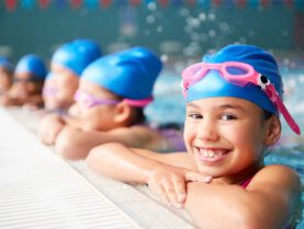 Children wearing swimming hats